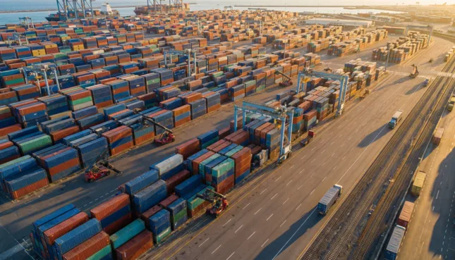 Container handling system — aerial view of a container yard with stacked containers and equipment